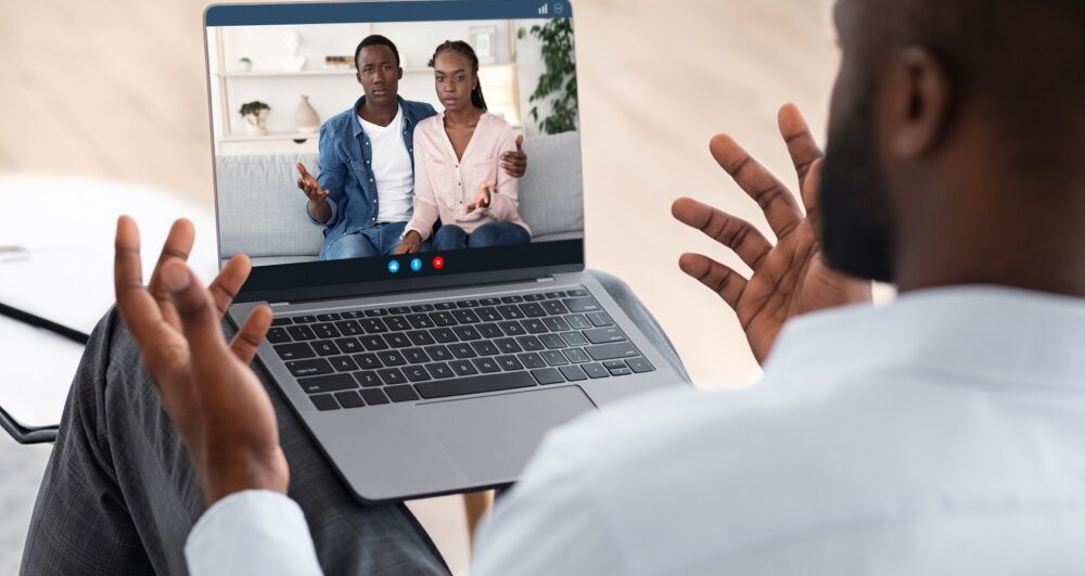 Therapist providing online therapy via laptop